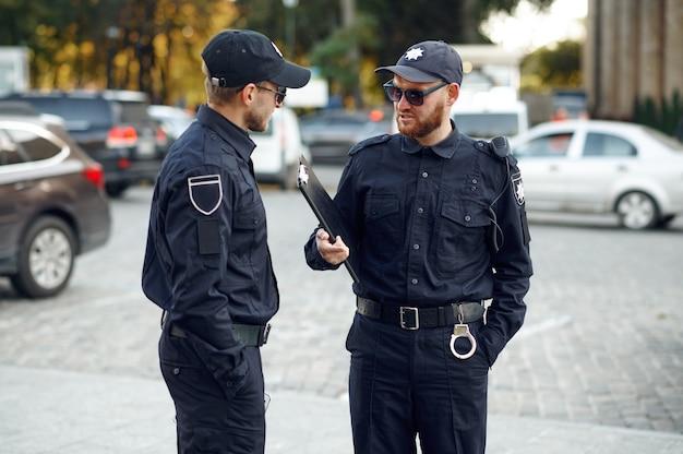 Two male police officers in sunglasses