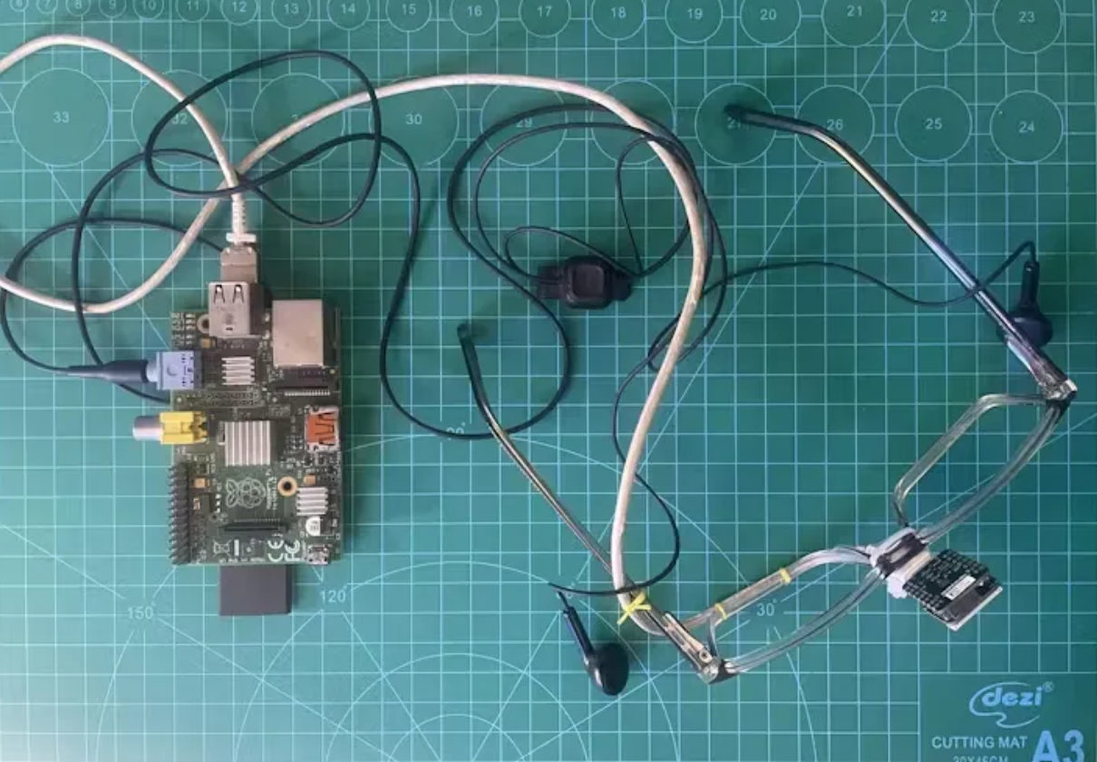 A circuit board with wires on a green surface

Description automatically generated