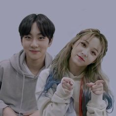 This contains an image of aespa Winter and  ENHYPEN Jungwon  posing for the camera with one pointing at the camera while the other holds his hand up