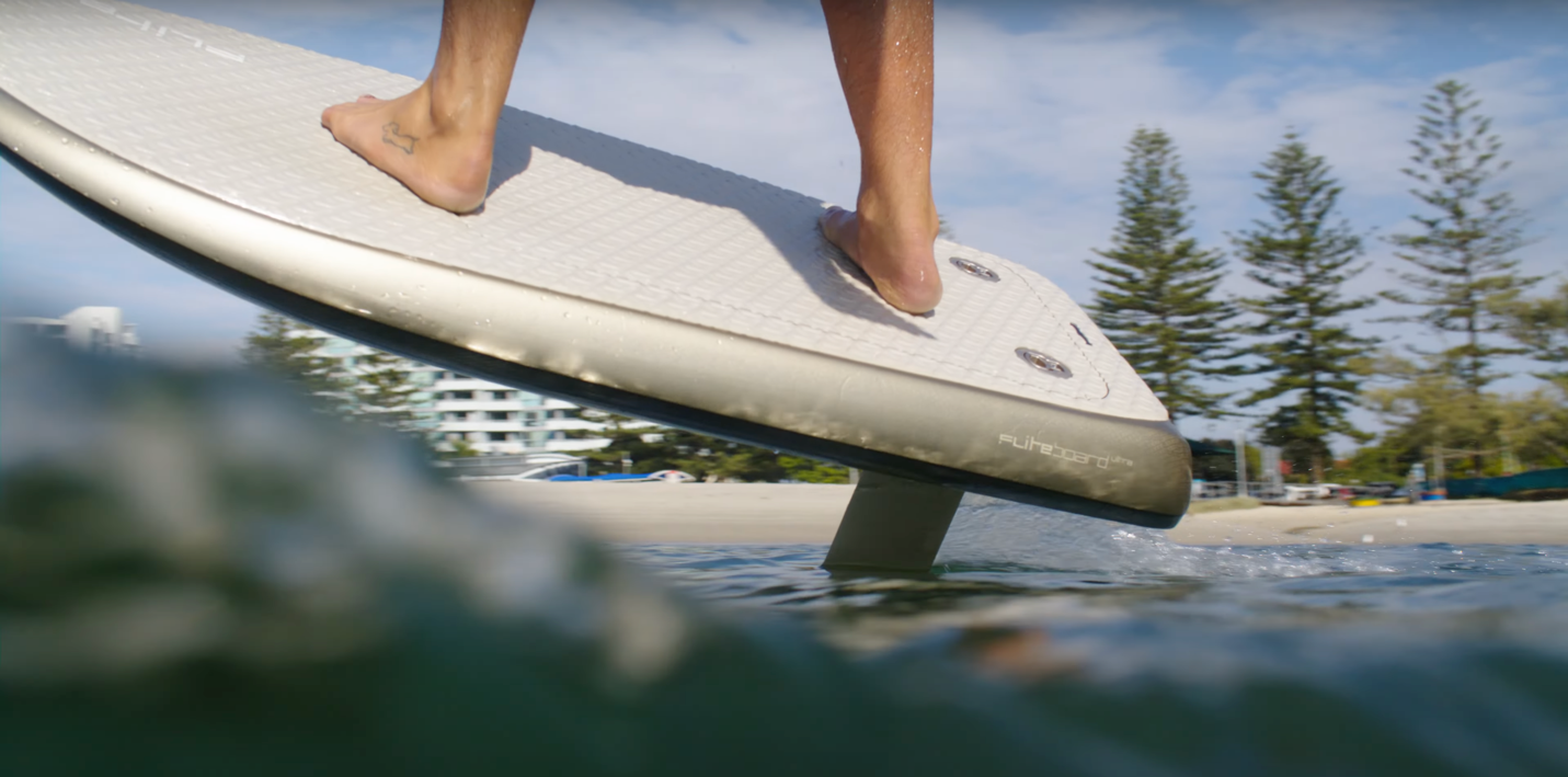 A person on a surfboard

Description automatically generated