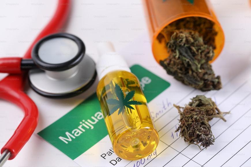 cannabis oil and weed flower on Doctor's prescription note pad