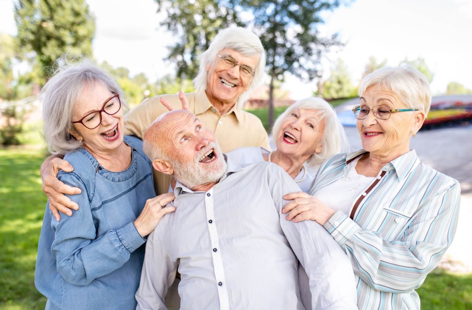 A group of happy senior residents enjoying their time together in a new assisted living community.