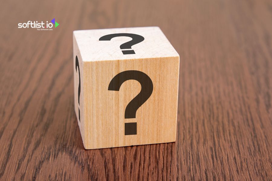 Wooden block with question marks on multiple sides on a wooden surface