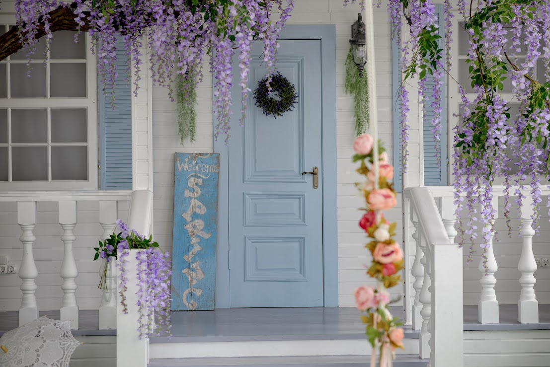 A close up view of a white house with a front porch. 