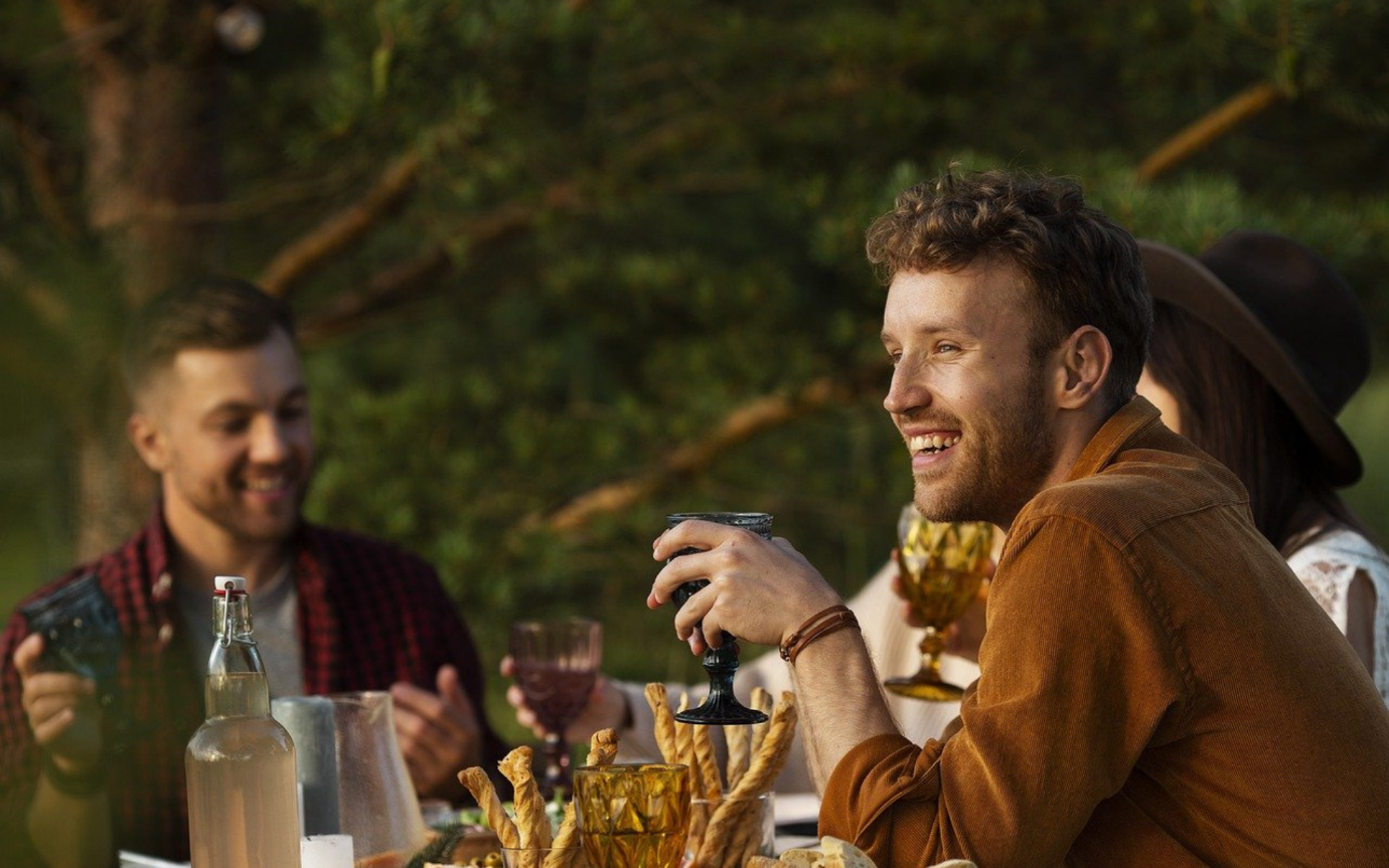 A group of men sitting at a tableDescription automatically generated