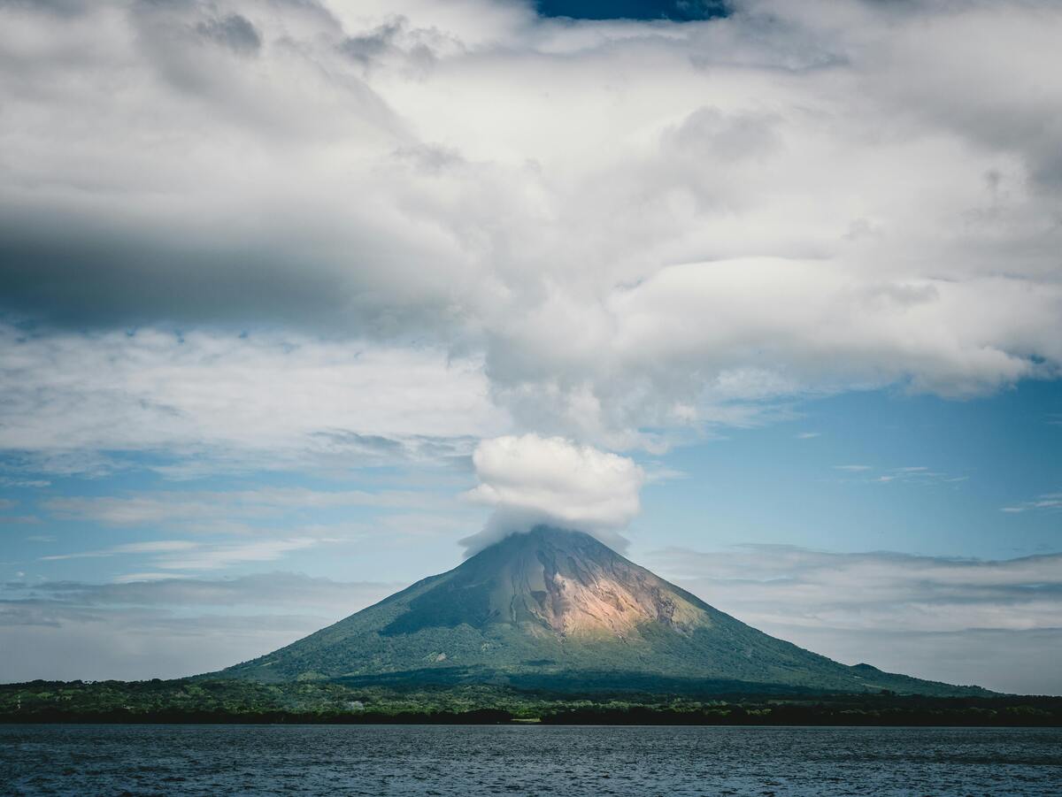Active volcano in Nicaragua emitting smoke, showcasing the country’s dramatic natural landscape and unique shipping destinations.