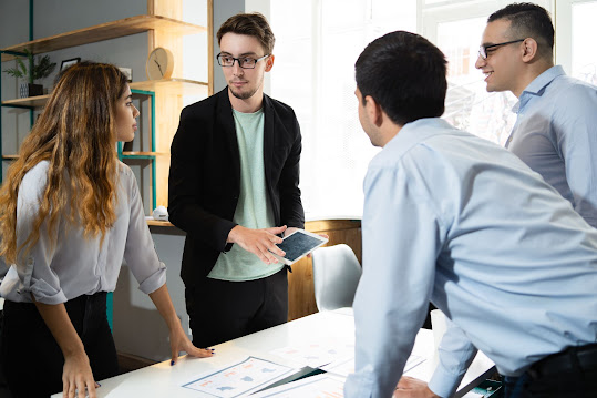 An employee having a discussion with his team about the medical leaves he has taken and in his absence, who all will be addressing his tasks.