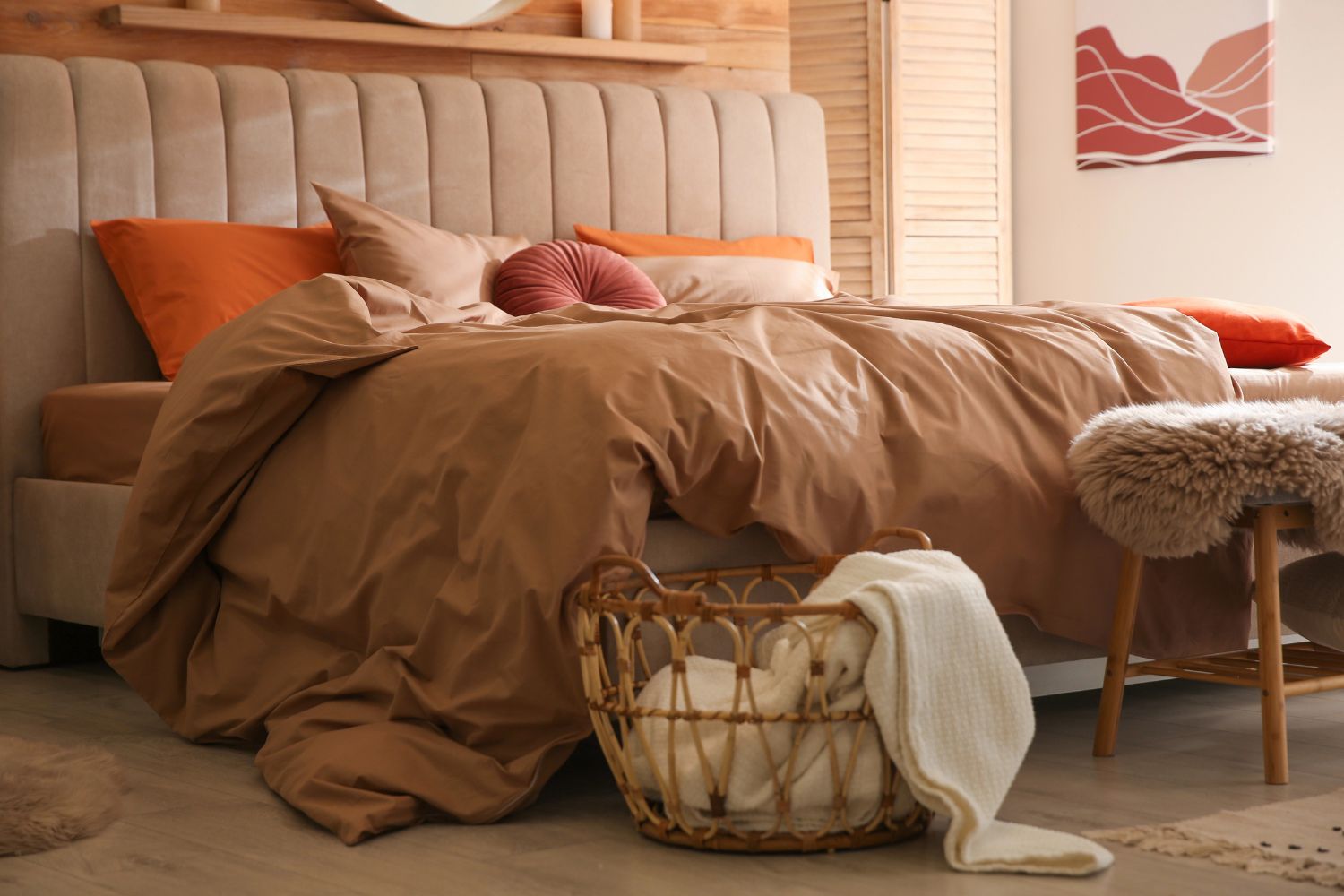 cozy bed with orange and brown bedding