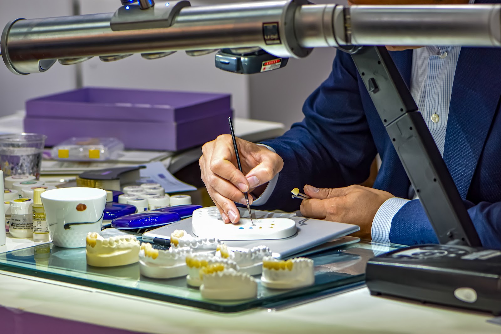 A professional performs dental implant surgery, placing an implant to replace a missing tooth with precision.