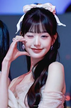 This contains an image of Wonyoung with her fingers on her chin