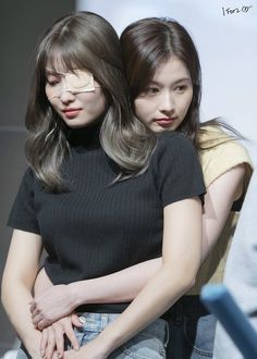 A picture of  momo and sana holding each other 