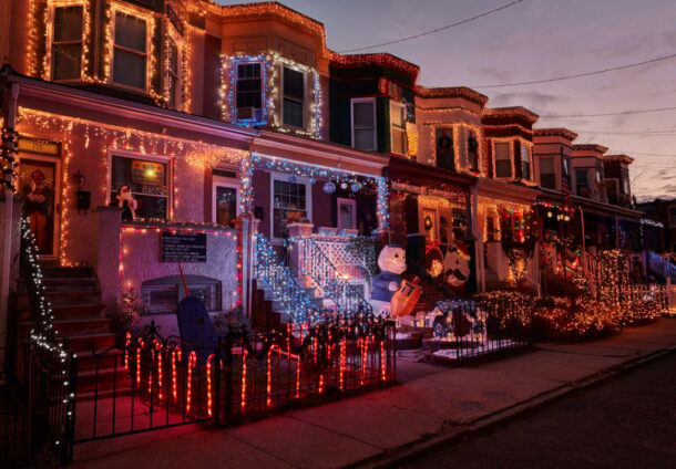 A view of rowhouses decorated for Christmas.