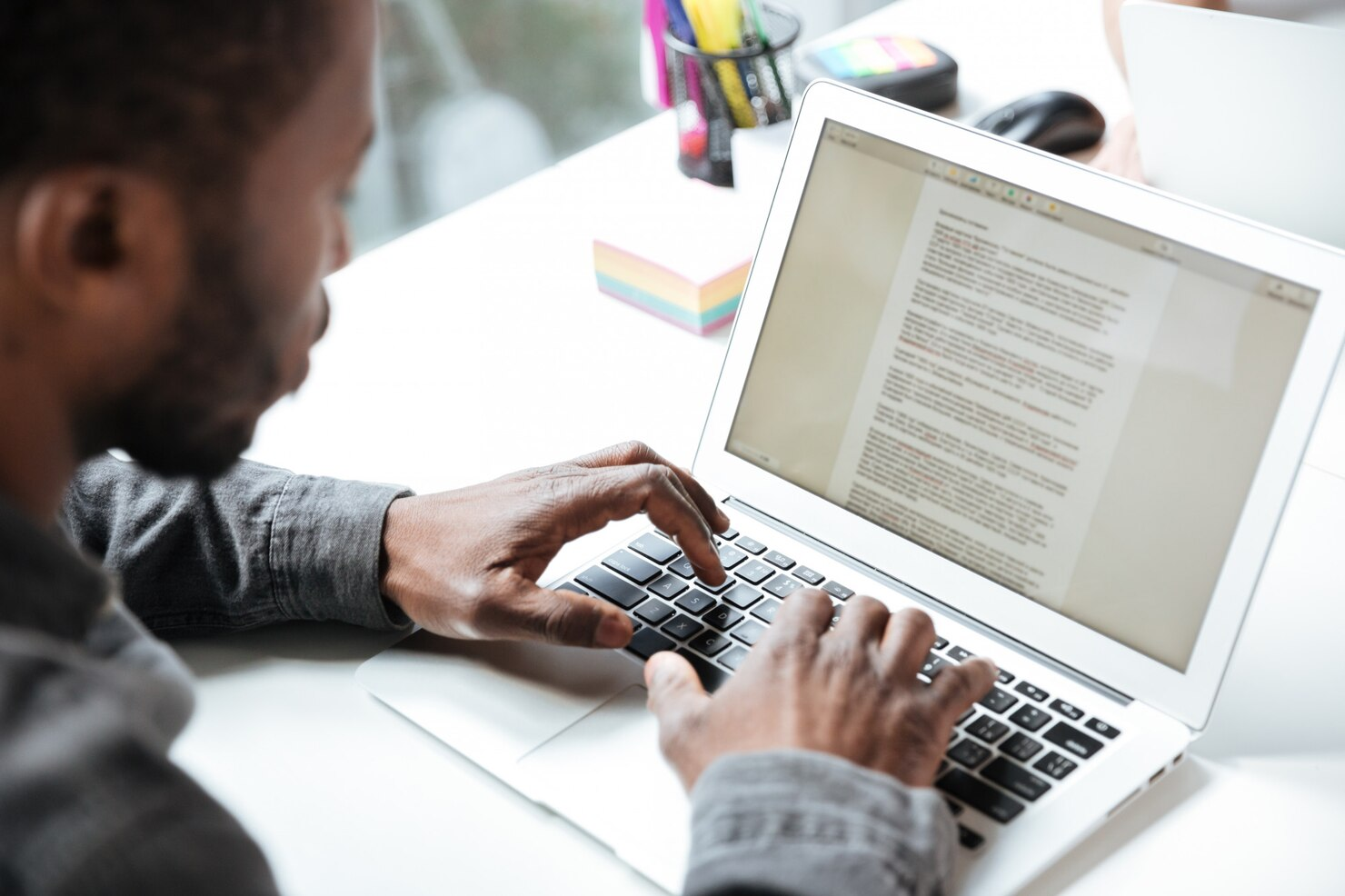 An author writing a blog on laptop.