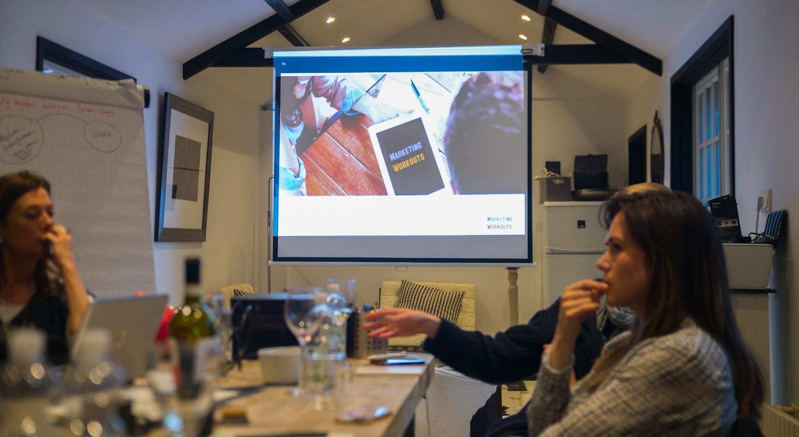 A projector being used front and center in a conference room