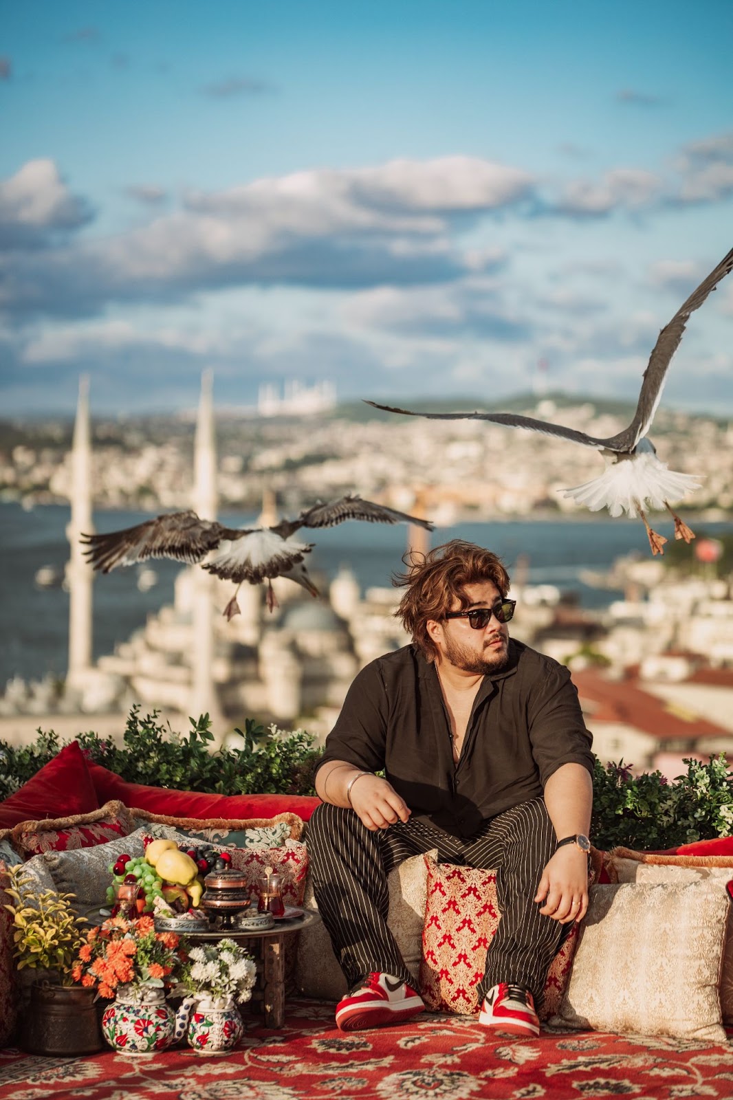 Tourist posing in Fatih with seagulls and mosque view
