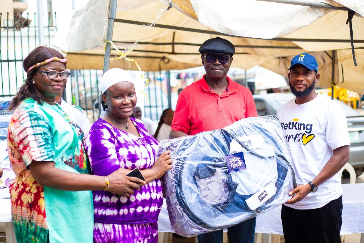 A group of people holding a bag of clothes

AI-generated content may be incorrect.