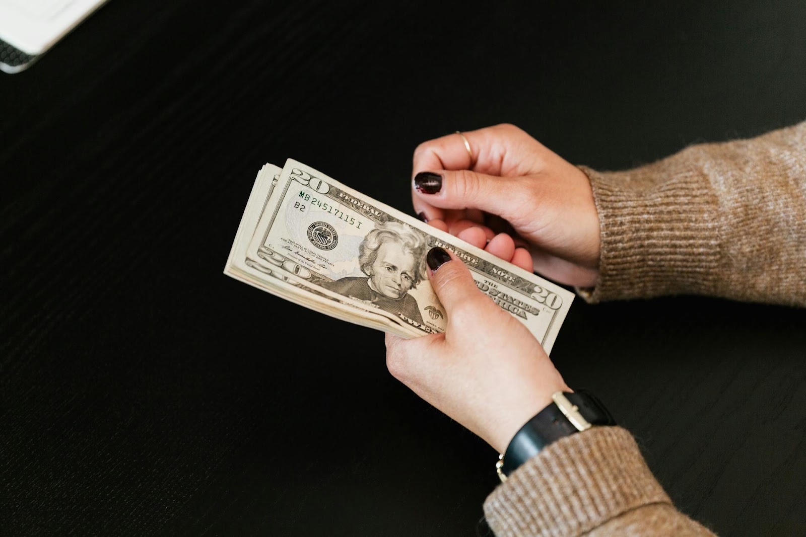 A woman holding money | Source: Pexels