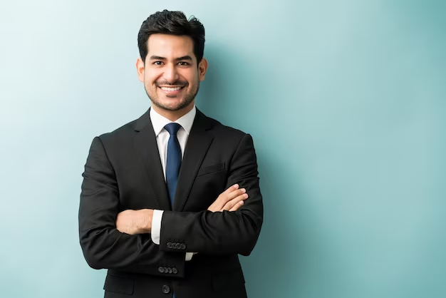 Man in black suit posing for his shot