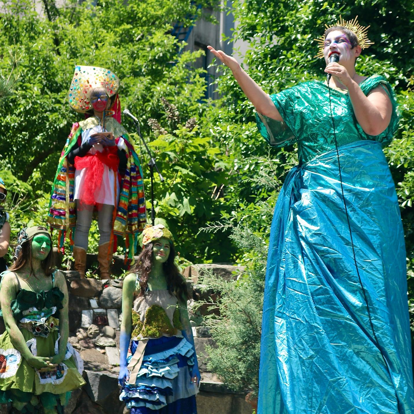 A person in a blue dress singing into a microphone

AI-generated content may be incorrect.