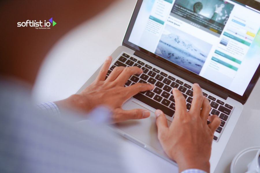 Person typing on a laptop with a webpage displayed