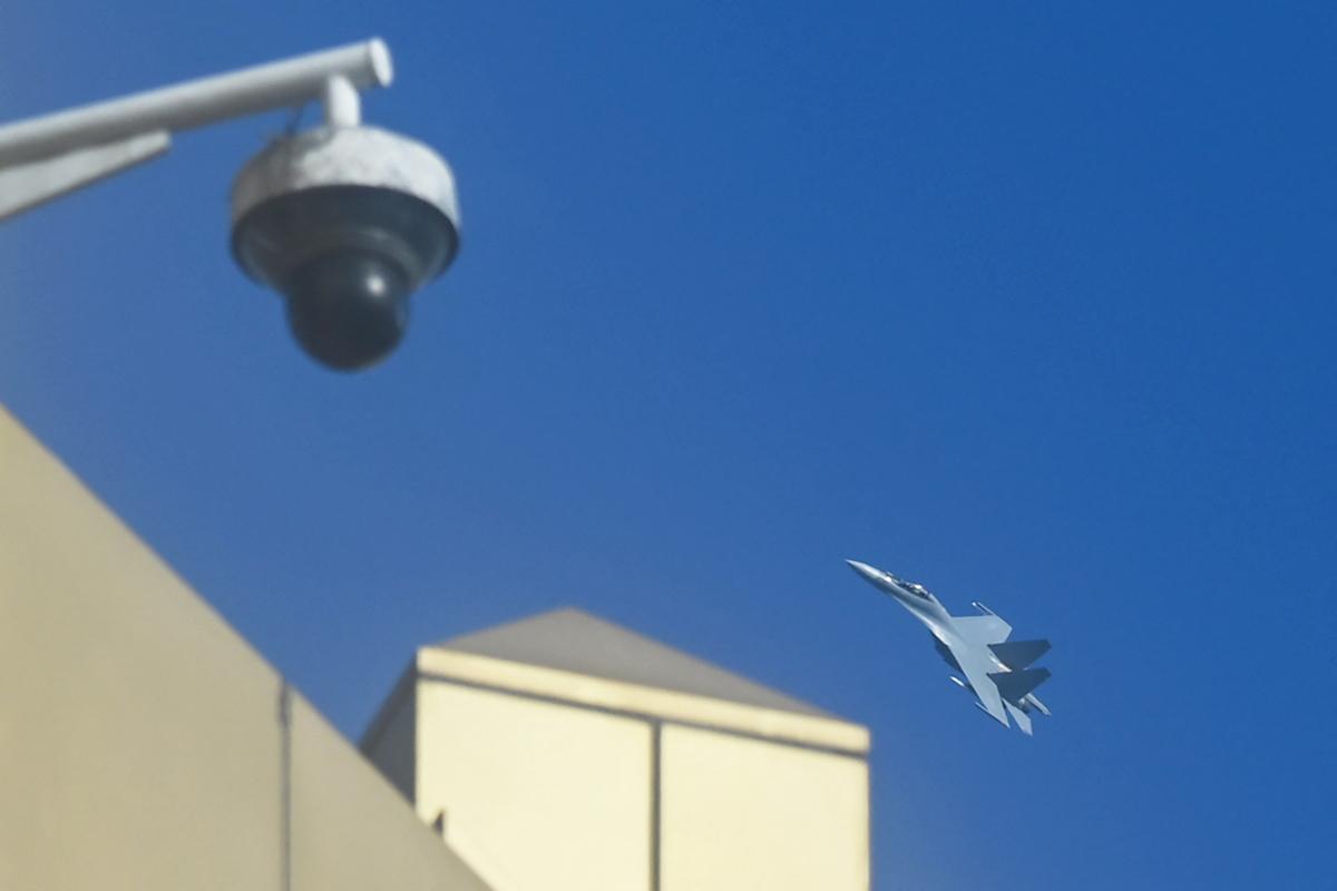 A camera and a jet flying in the sky

Description automatically generated