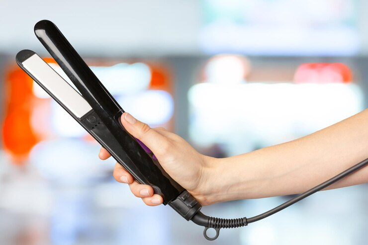 Woman holding hair straightener