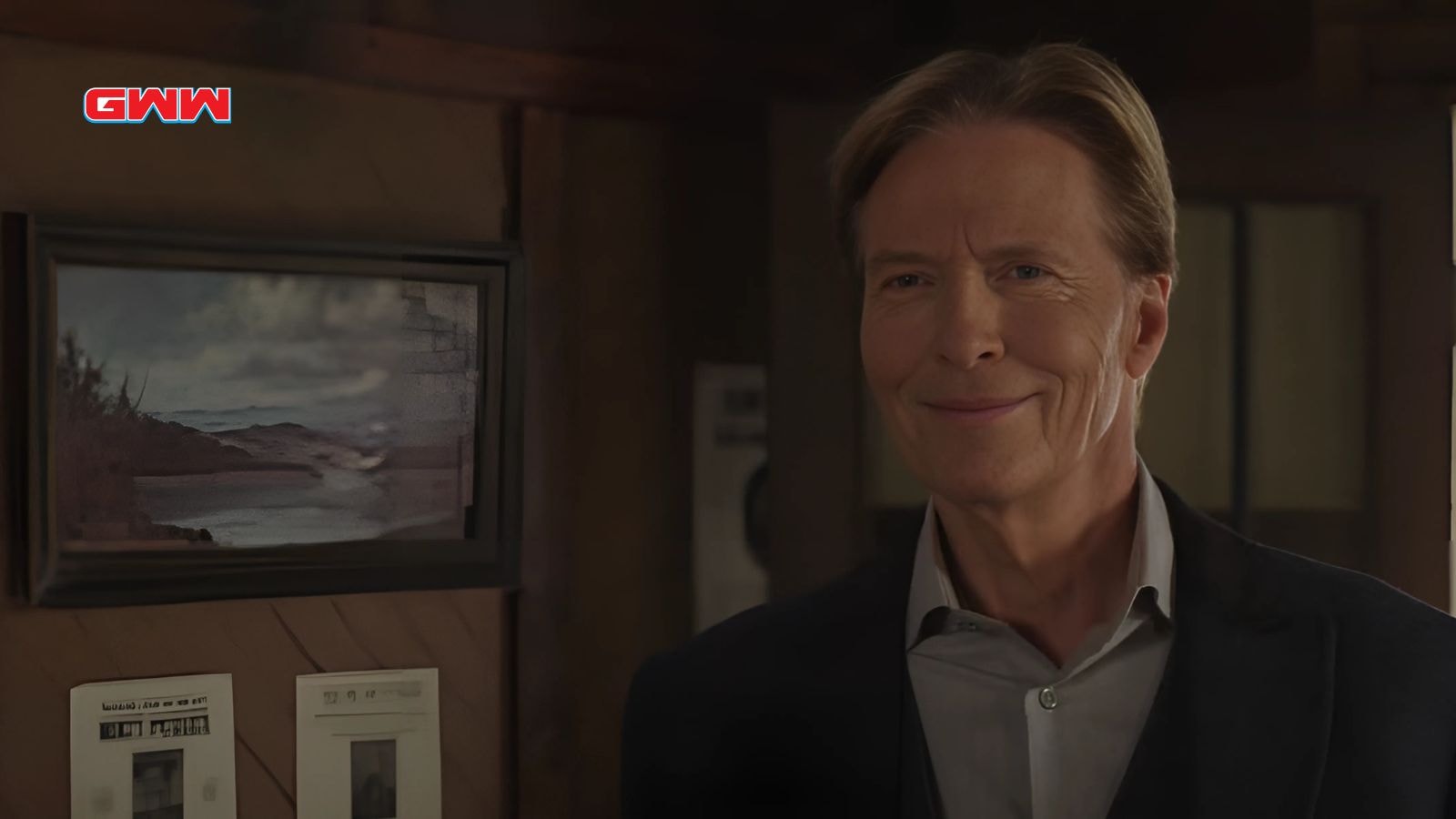 Jack Wagner as Bill Avery smiling while standing in a cozy wooden room