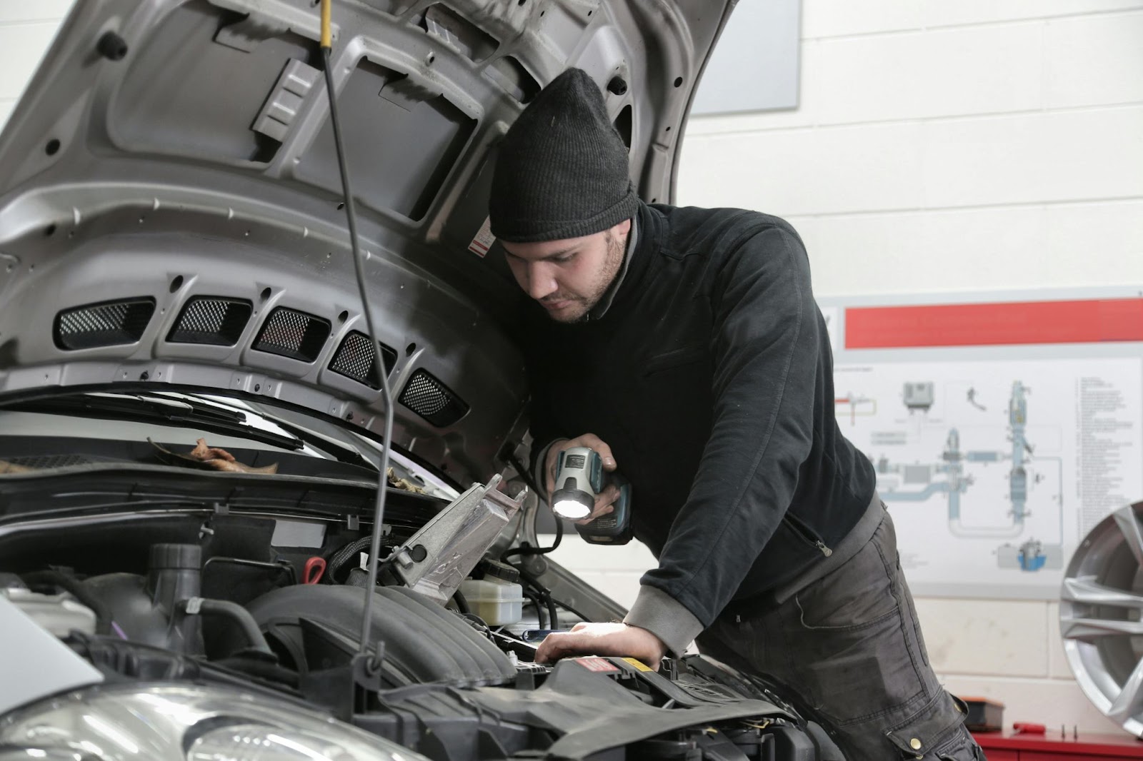 man inspecting car engine