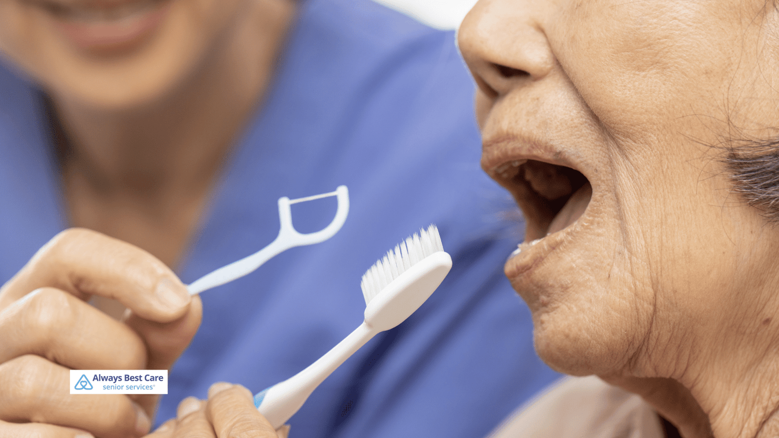 This is an image of a senior woman brushing her teeth with a caregiver assisting