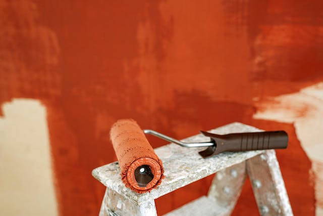 A wall being painted bright orange.