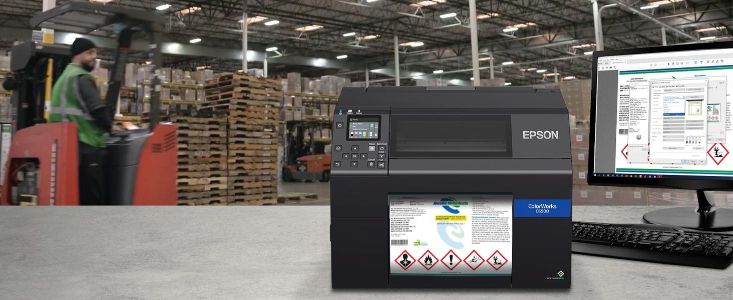 Close-up of an Epson C6500A label printer, showing the print head and a partially printed label.