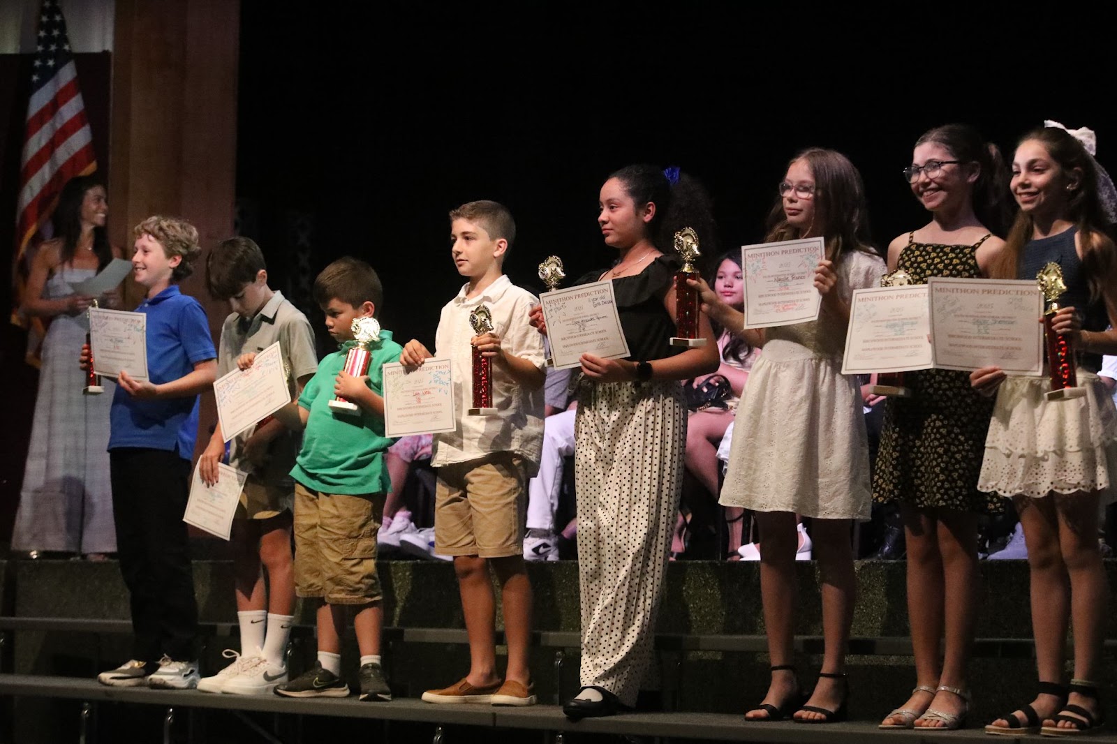 kids on risers with certificates