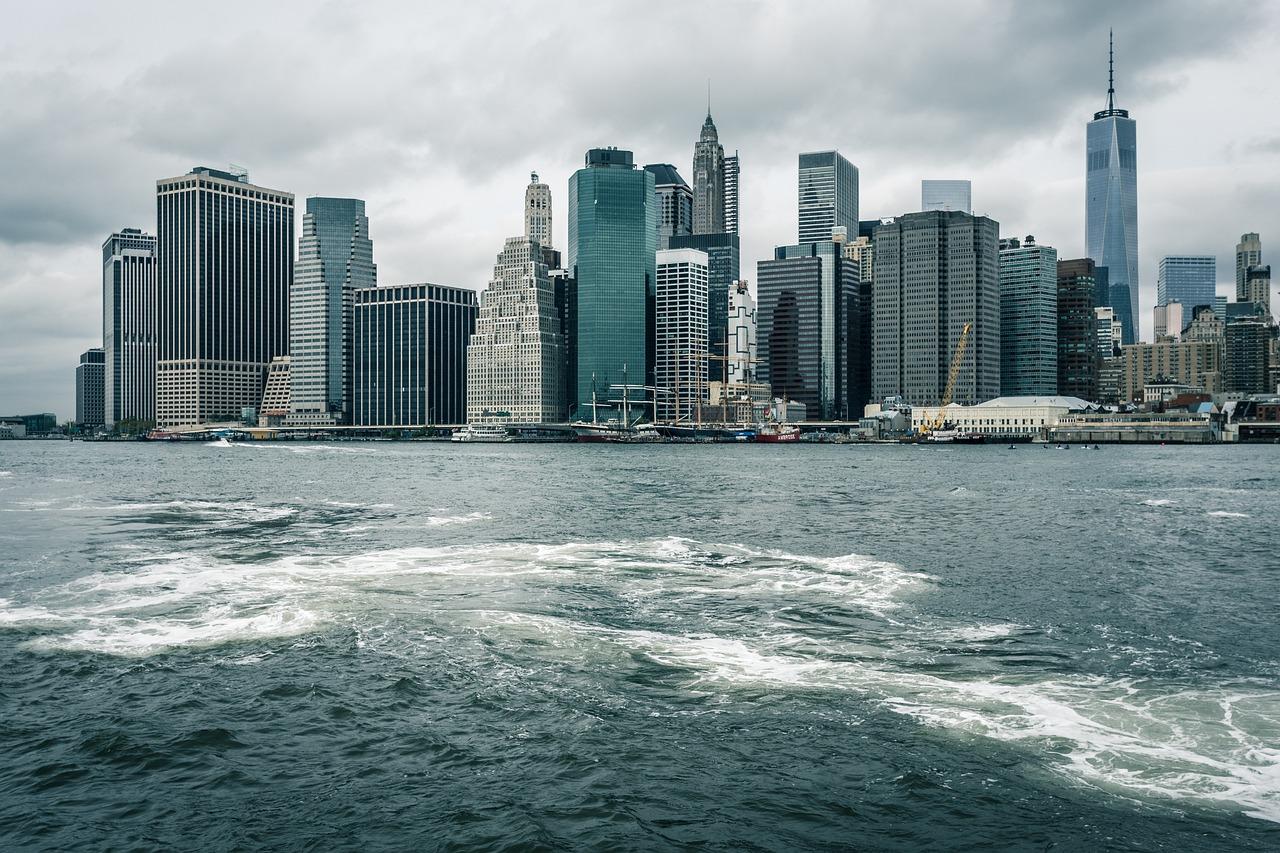 A city skyline with water behind it

Description automatically generated