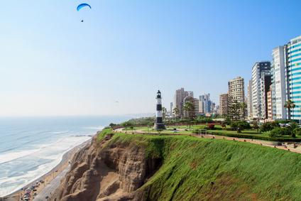 A lighthouse on a cliff by the ocean

Description automatically generated