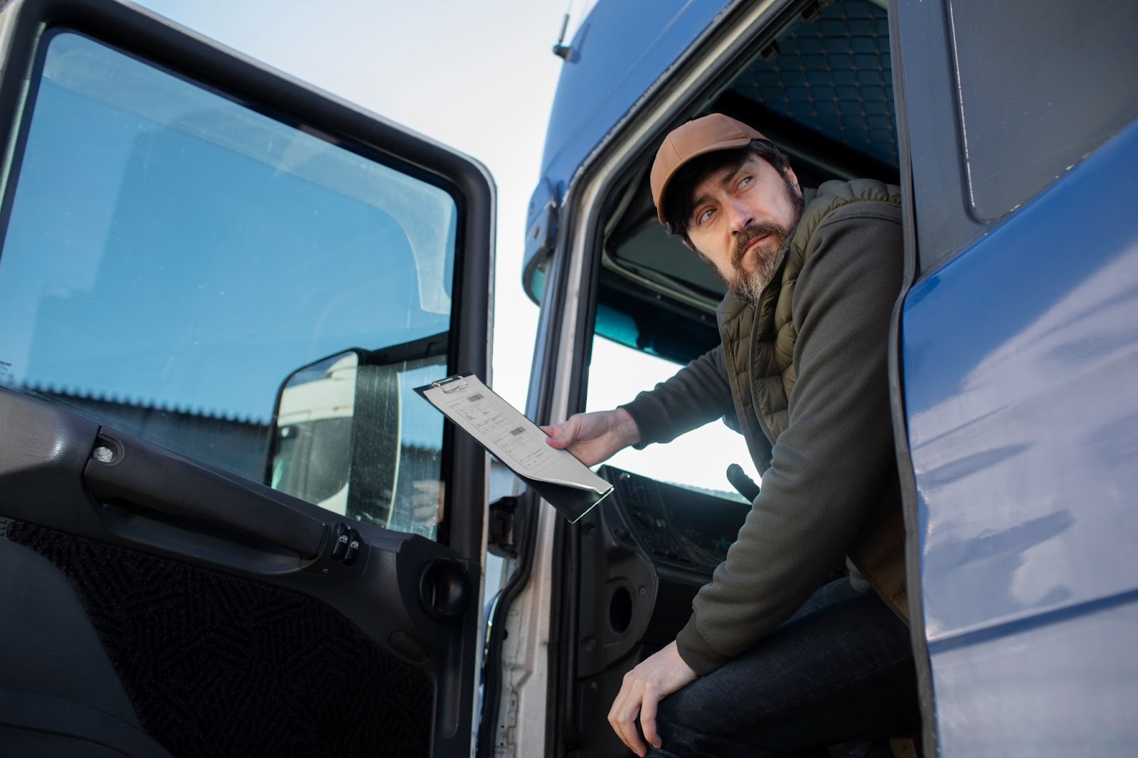 A truck driver holding a document