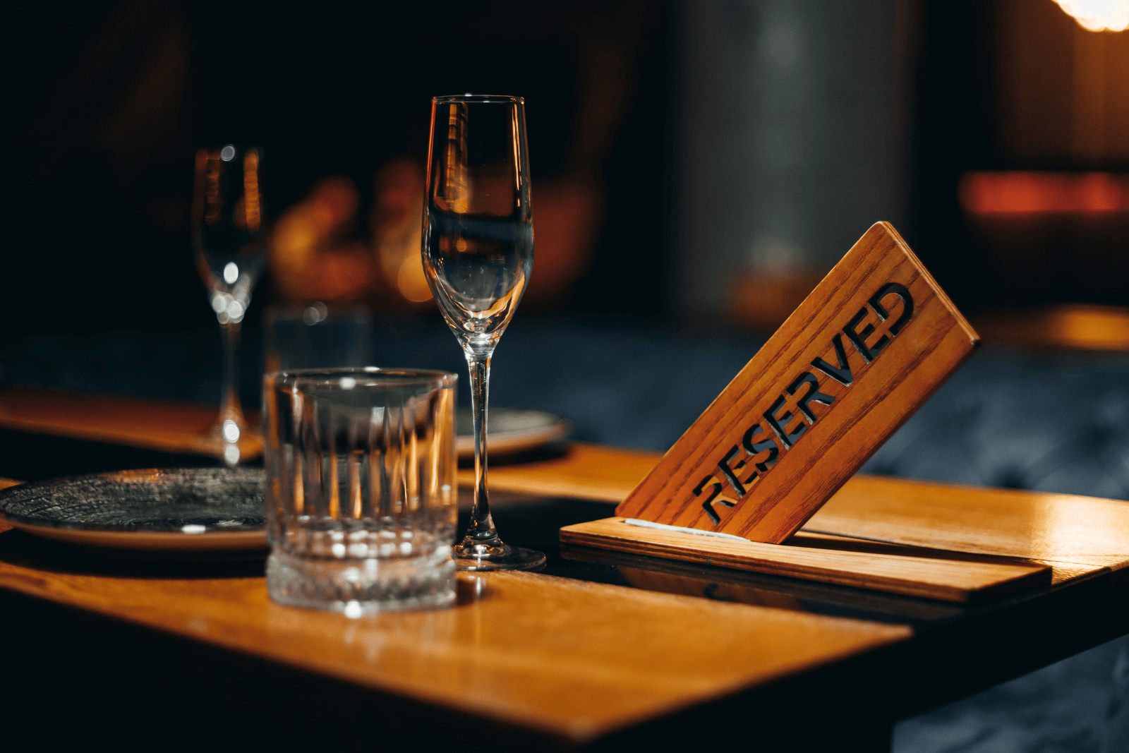 Reserved table with a wooden sign and glasses