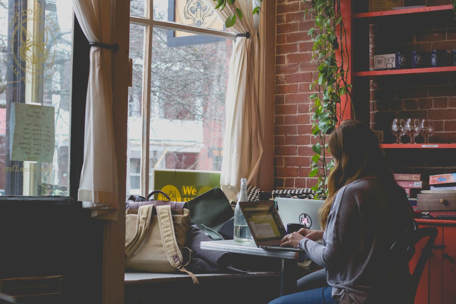 Woman working on her laptop in a cafe