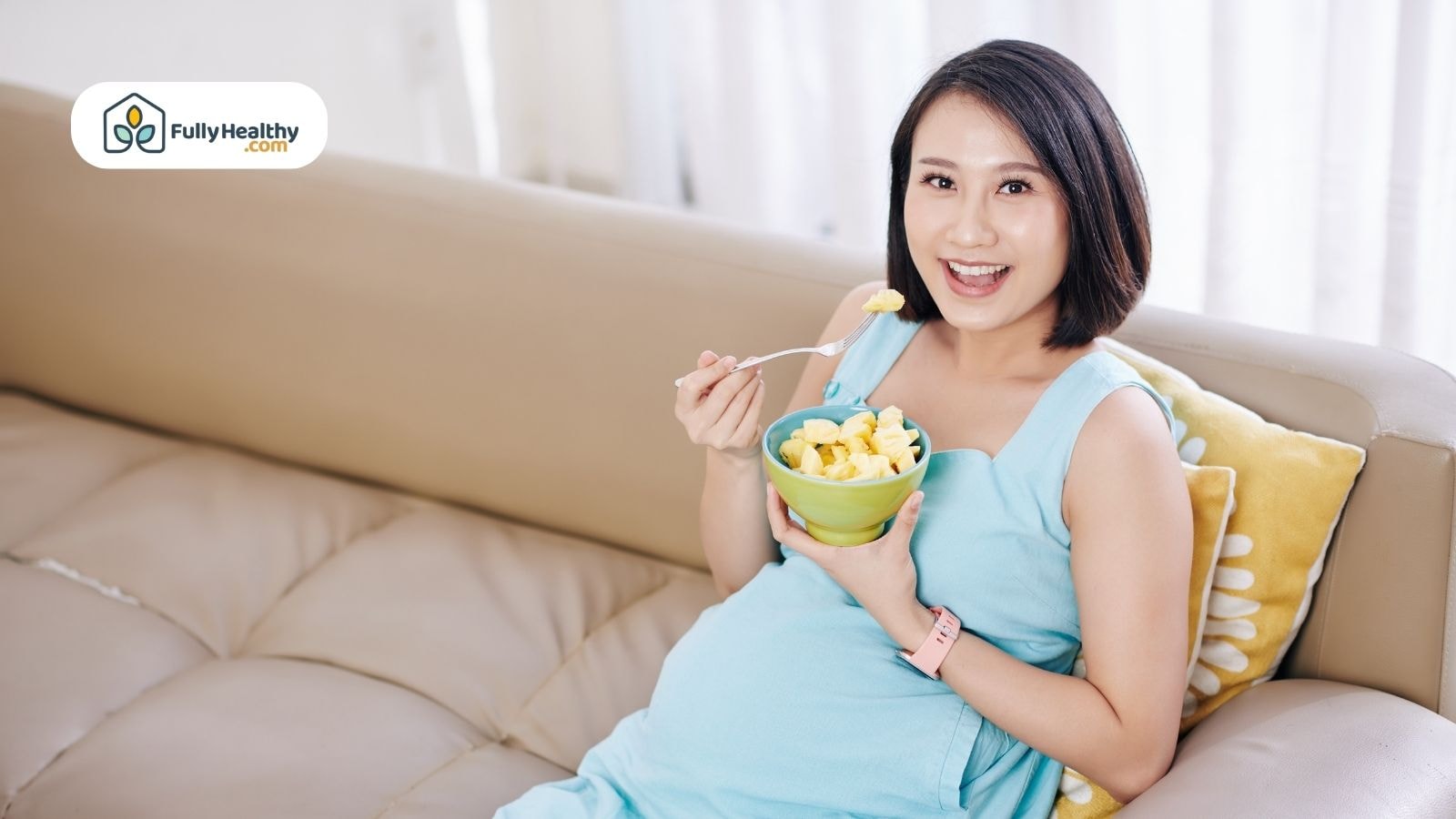 Pregnant woman smiling while eating fresh pineapple chunks