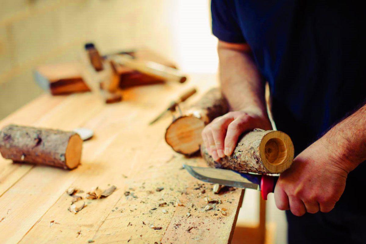 stock-photo-man-making-rustic-wooden-candle-holders-tealights-workshop