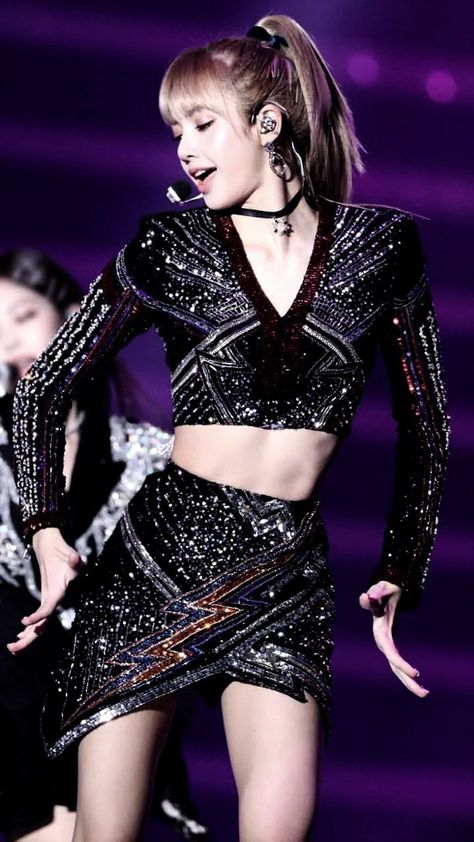 This contains an image of Lisa on a black dress dancing on the stage