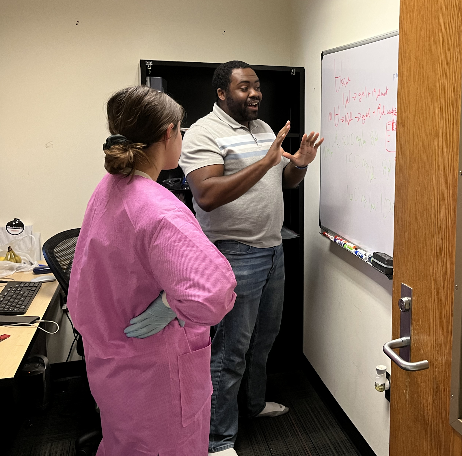 Dr. Bullock explaining a protocol for plant genetic engineering to his summer research student.