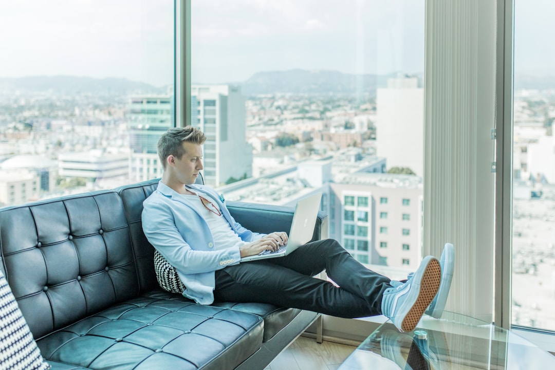 A businessman using a laptop to evaluate pricing and support options for multi-channel marketing automation solutions