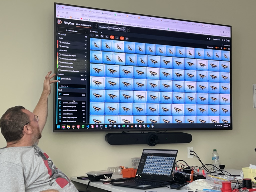 Photo of Andy demonstrating the machine learning workflow for detecting insects in the images captured by the Mothbox. 