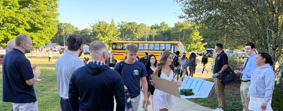 image of staff greeting students on the first day of school