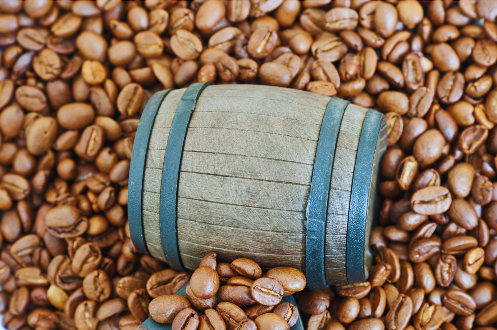 An illustration depicting the art of aged coffee with coffee beans and barrels.