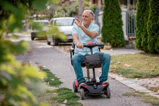 A senior riding  a mobility scooter strolling in the neighborhood