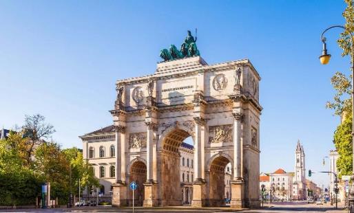 A large stone arch with a statue on top

Description automatically generated