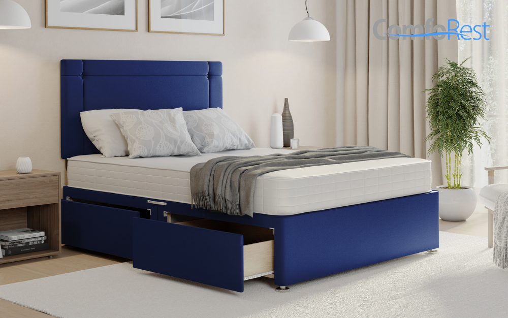 Blue divan bed with open storage drawers in a modern bedroom
