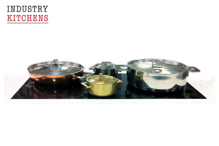 Various pots and pans displayed on a black surface, demonstrating compatibility with induction cooktop cooking.