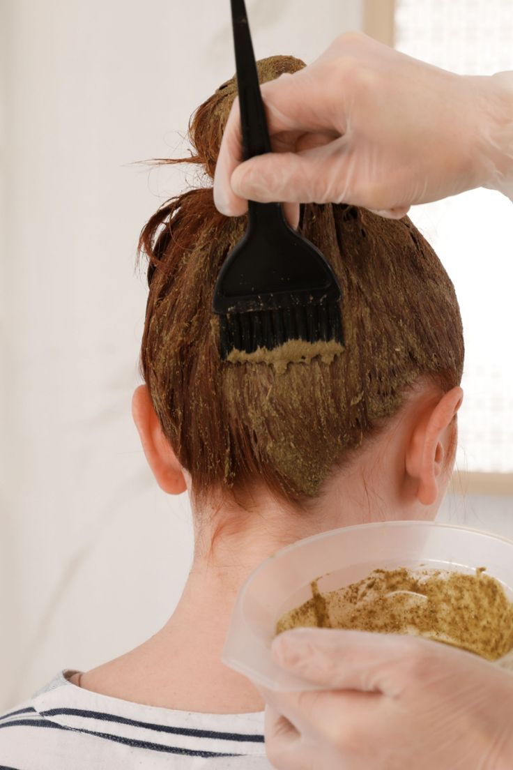 Woman applying Henna on her hair